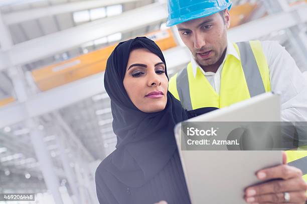 Checking Progres Together Stock Photo - Download Image Now - Construction Worker, Dubai, 2015