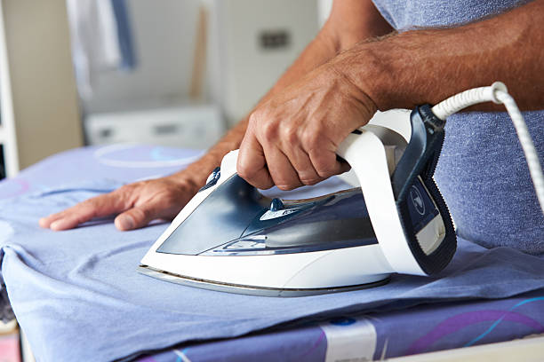 istock Close Up Of Man Ironing Laundry 469207312