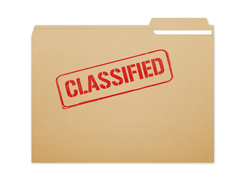 Classified brown folder file with paper showing with a lot of copy space. Isolated on a white background with clipping path.