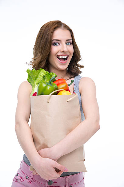 istock woman holding a shopping bag 469210966