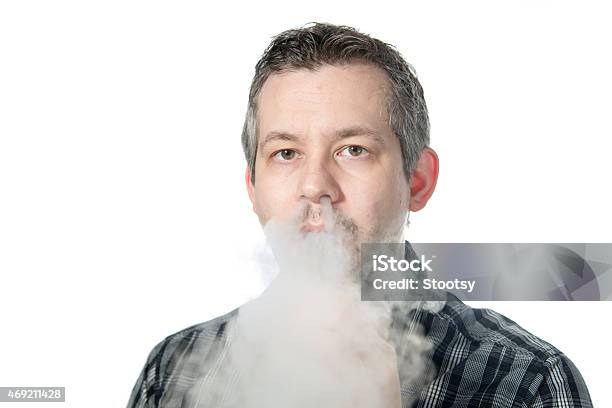 Man Exhaling Smoke Stock Photo - Download Image Now - 2015, Addiction, Adult