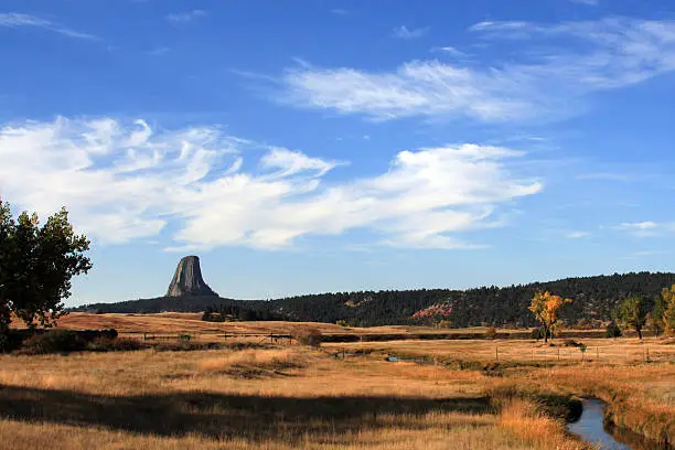 Devils Tower National Monument in Wyoming USA with a stream meandering through the foreground