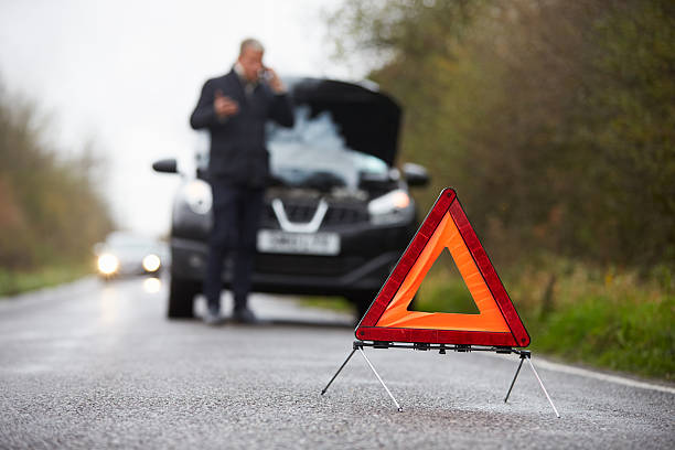 istock Motorist Broken Down On Country Road Phoning For Help 469212310