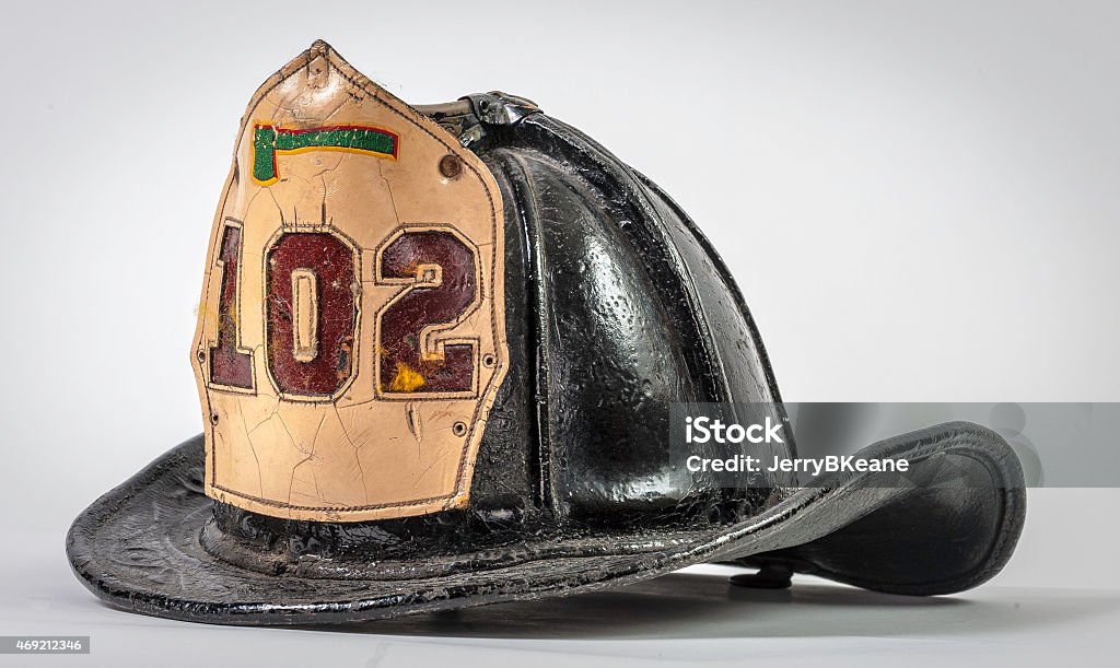 Antique Leather Fire Helmet from New York City Antique Leather Fire Helmet from New York City emblazoned with white lieutenant's Shield Firefighter's Helmet Stock Photo