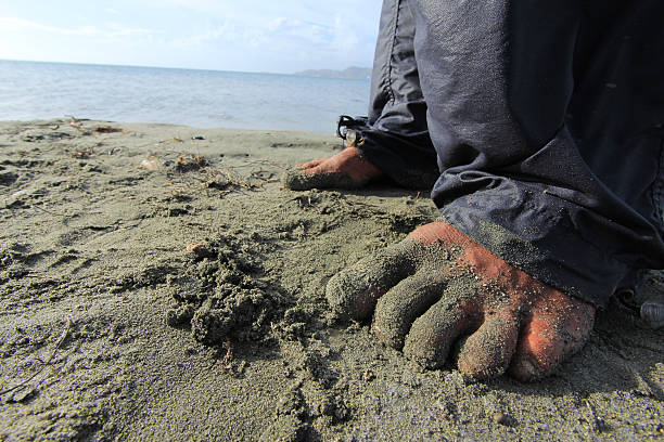 feet on beach sand stock photo