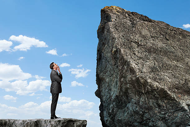 istock Businessman looking up at a mountain peak 469212892