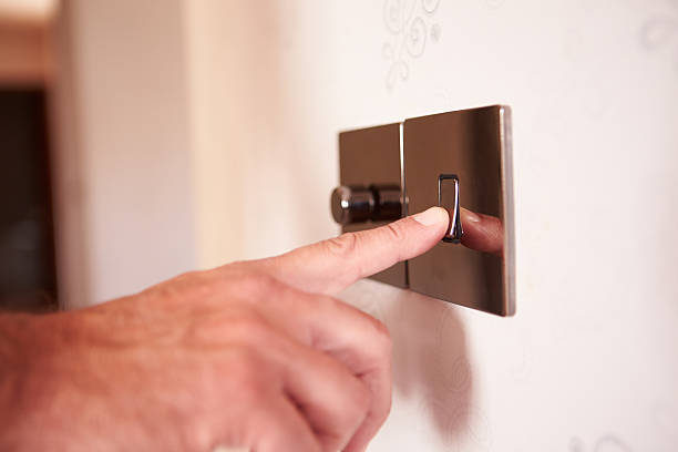 istock Close Up Of Man Turning On Electric Light Switch 469213014