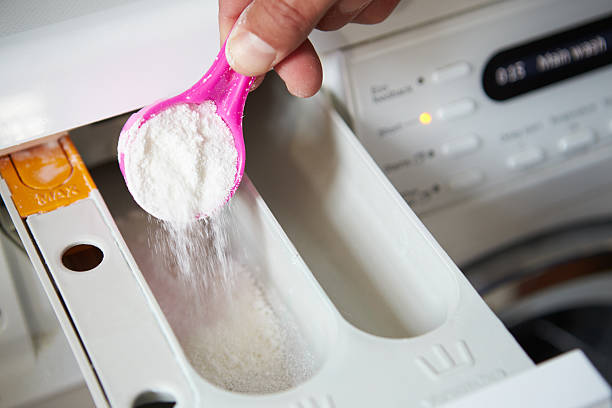istock Close Up Of Man Putting Detergent Into Washing Machine 469214782