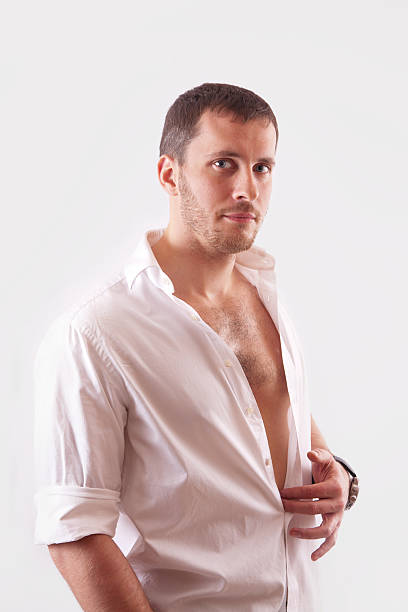 istock Young man with beautiful face, dressed in white unbuttoned shirt 469217850