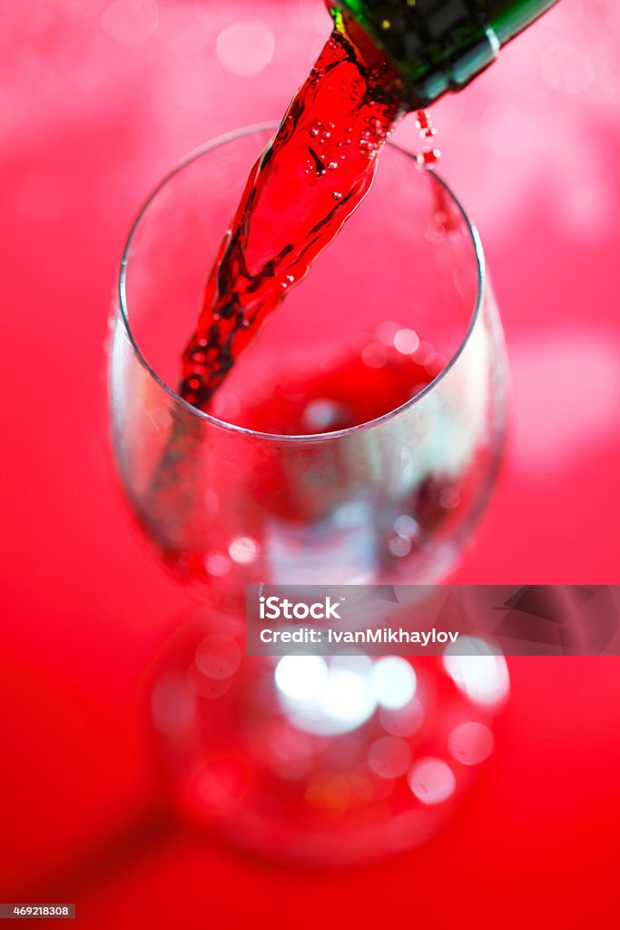 Red wine pouring Red wine pouring from bottle into glass close-up Directly Above Stock Photo