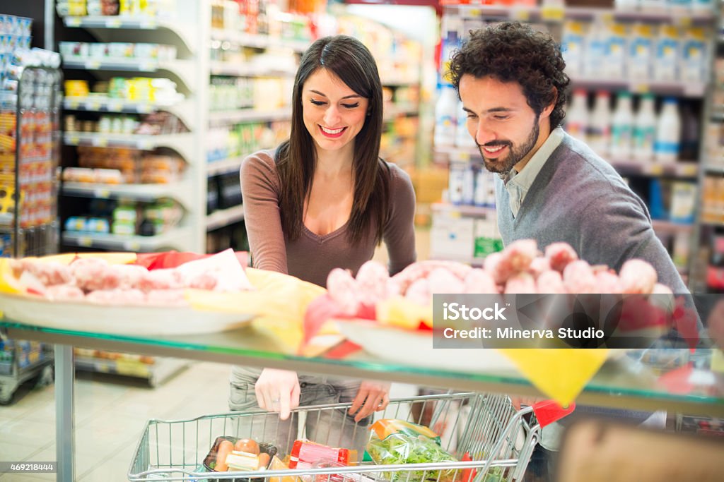 Couple shopping in a supermarket Young couple shopping in a supermarket 2015 Stock Photo