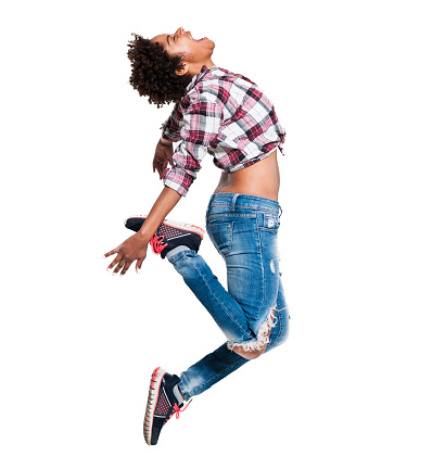 Beautiful young African woman jumping and smiling. Studio shot, isolated on white