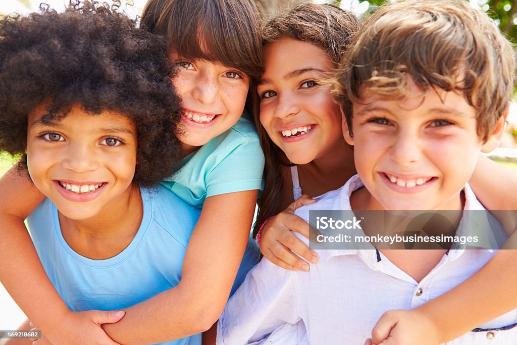 Group Of Children Giving Each Other Piggyback Rides Child Stock Photo