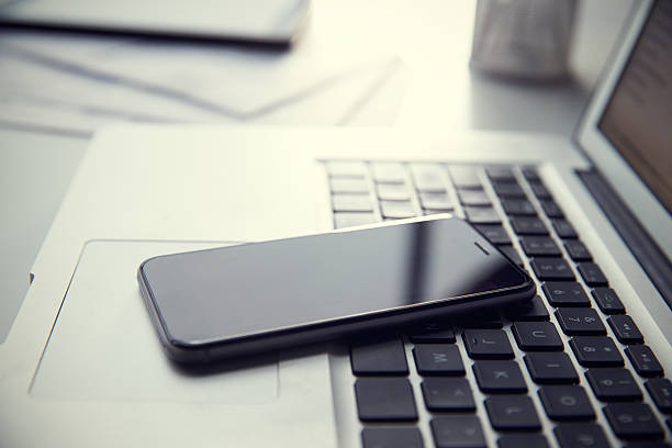 istock Mobile Phone Resting On Laptop Keyboard 469218740
