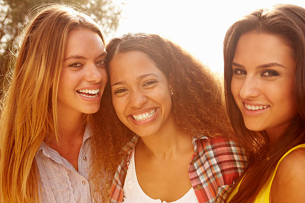 istock Three smiling female friends outdoors 469218912