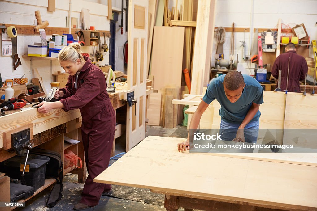 Staff Working In Busy Carpentry Workshop Carpenter Stock Photo