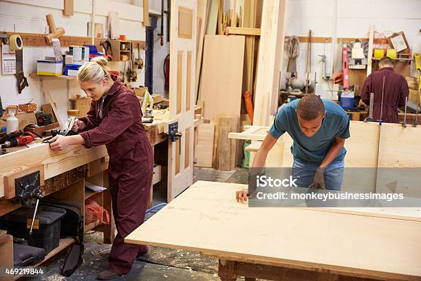 Staff Working In Busy Carpentry Workshop Stock Photo - Download Image Now - Carpenter, Teenager, 18-19 Years