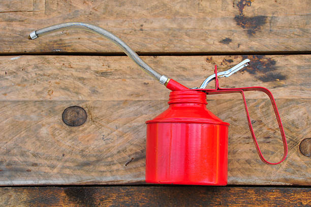istock Oil can on wooden background 469219990
