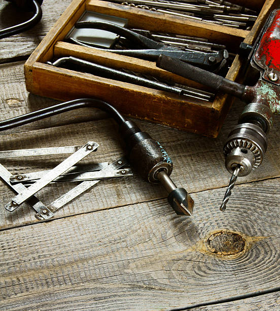 istock Drills in box, drill, chisel on a wooden background 469220132