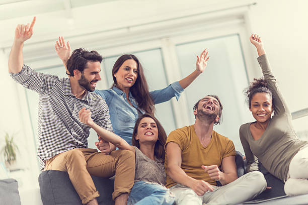 istock Young cheerful people with raised hands at home. 469224228