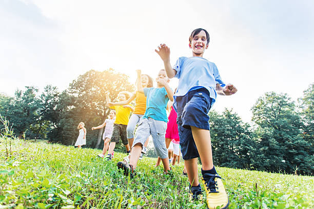 istock Low angle view of happy kids having fun in nature. 469224260