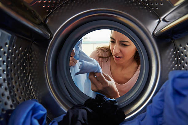 istock Woman looking quizzically at laundry from the dryer  469224380