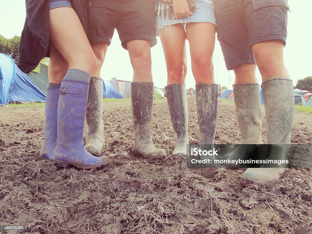 Close Up Of Friends In Wellington Boots Walking To Festival Stock Photo Download Now - iStock