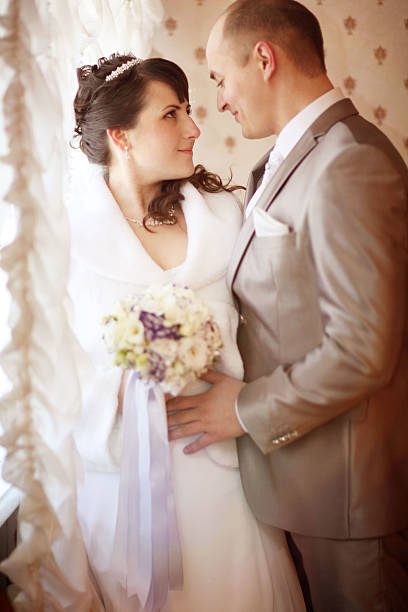 istock groom kisses the bride at the reception 469225766
