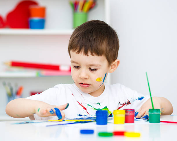 istock Little boy is playing with paints 469230424