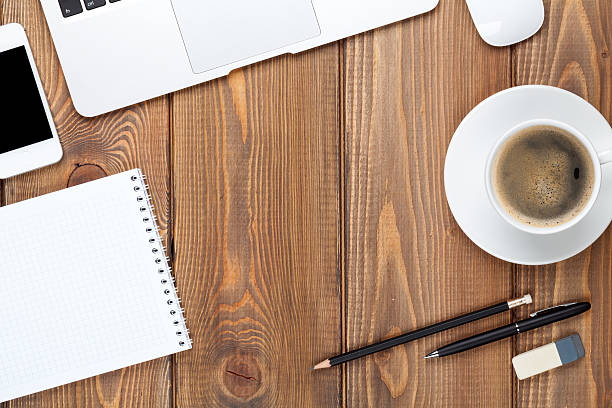 istock An office desk with a computer, supplies, and a coffee cup 469231814