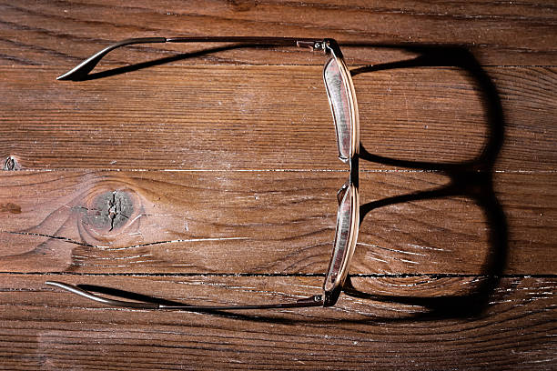 istock Old glasses on wooden table 469235616
