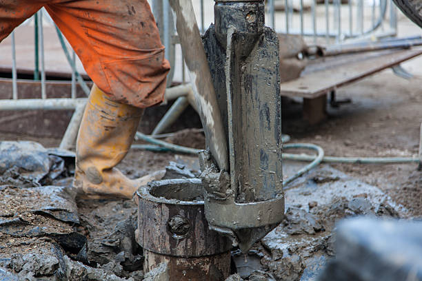 istock Borehole for soil testing drill bit being cleared of clay 469238028