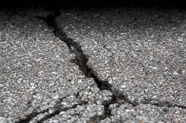 Cracked road on asphalt close up