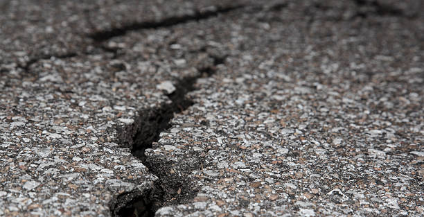 istock Cracked road on asphalt close up 469241282