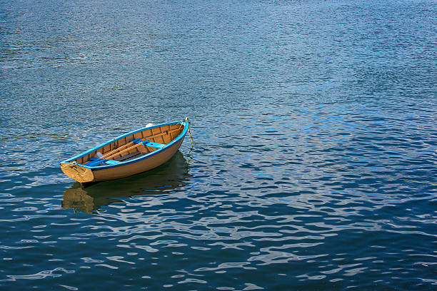istock Small row boat sitting calmly in a harbor 469241974