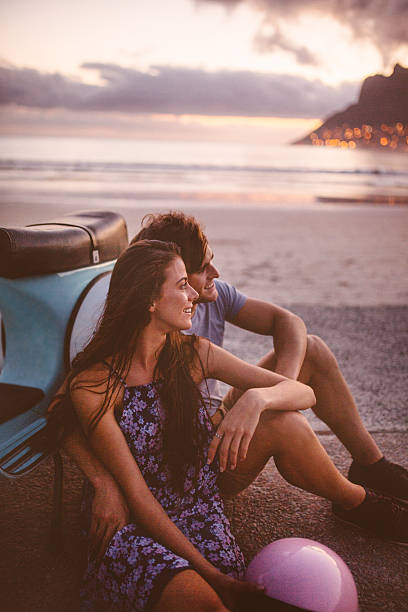 istock Couple with their scooter at the beach on summer evening 469242312