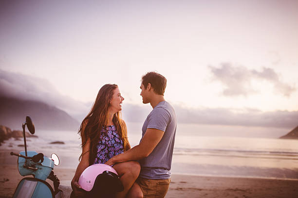 istock Young couple and their scooter on a beach road trip 469242314