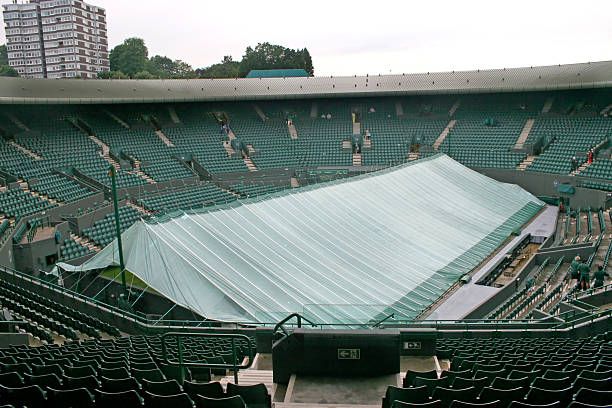 Covered Tennis Court A tennis court covered because of bad weather wimbledon seats stock pictures, royalty-free photos & images