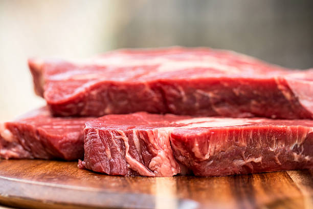 istock Fresh beef steaks on wooden board 469245818