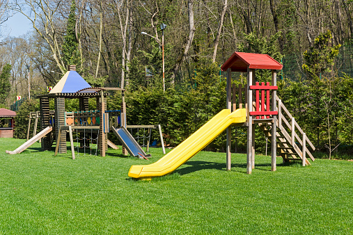 A large garden with children's playground in the green