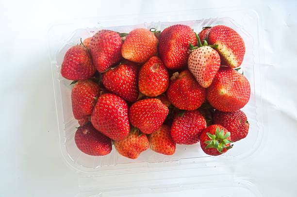 istock Box or punnet of strawberries isolated on a white background. 469250610