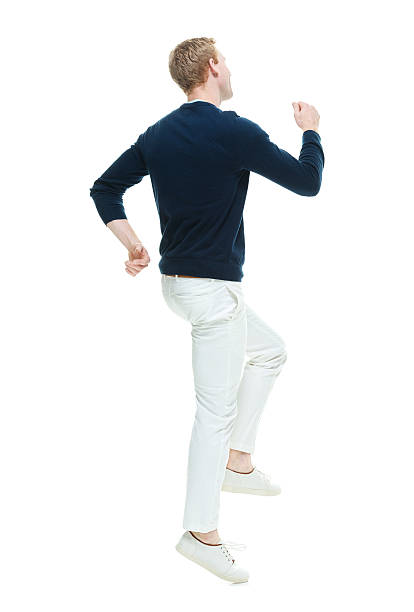 istock Rear view of casual man hopping 469251050