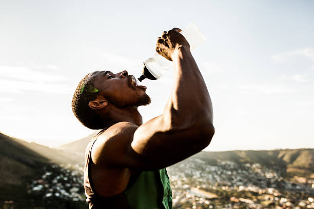 istock Thirsty African American athlete drinking water with wide open m 469251962