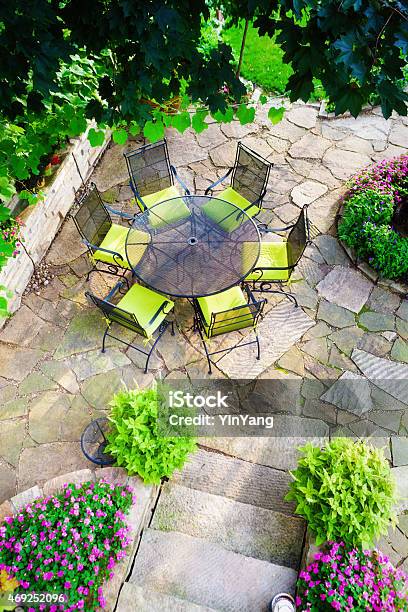 Landscaped Stone Patio Back Yard With Garden And Flower Beds Stock Photo - Download Image Now