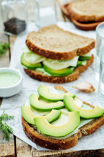 istock sandwiches with avocado, cheese, cabbage and cheese and herb topping 469252262