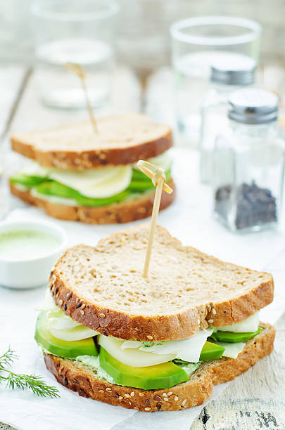 istock sandwiches with avocado, cheese, cabbage and cheese and herb topping 469252288