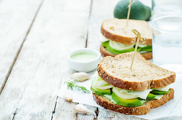 istock sandwiches with avocado, cheese, cabbage and cheese and herb topping 469252294