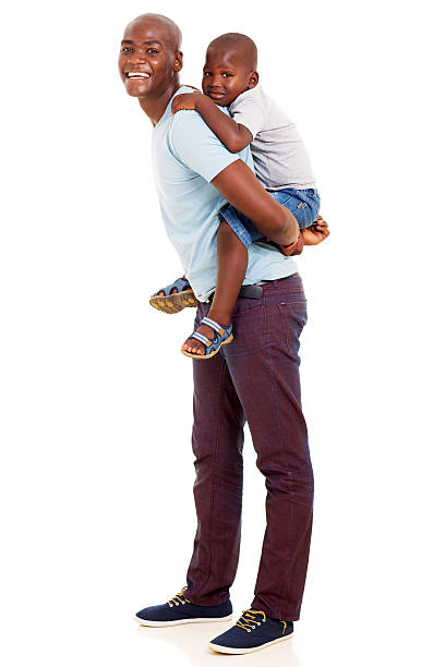 istock african father giving his son piggyback ride 469253424