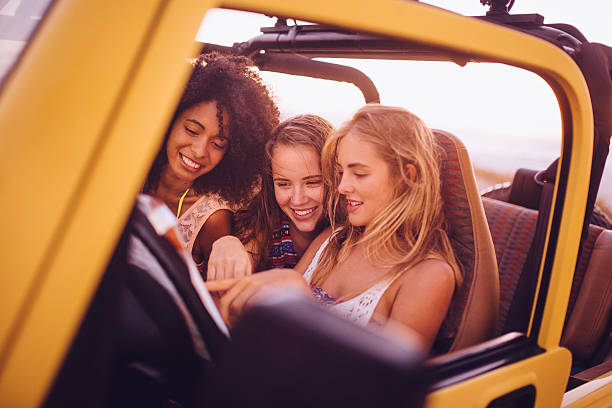 istock Mixed racial group looking at map on a road trip 469256982