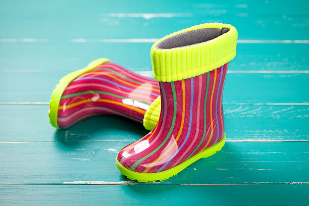 istock Baby rubber boots on turquoise table 469258354